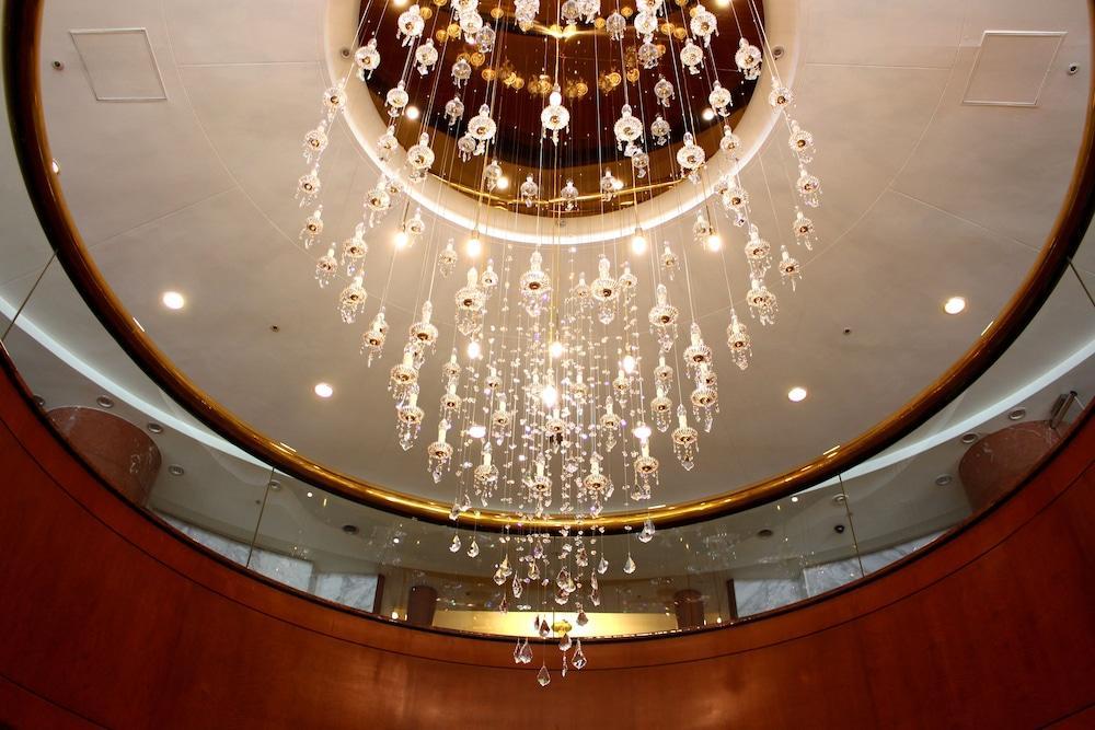 Evergreen Laurel Hotel - Tchaj-čung Exteriér fotografie The photo shows an elegant chandelier hanging from a ceiling. The chandelier features numerous hanging crystals that reflect light, creating a sparkling effect. The ceiling itself is circular and designed with a smooth surface, accented by a circular